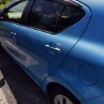 Rear door and fuel flap of the light blue Toyota Aqua