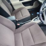 Front seats and shift lever inside the Toyota Aqua